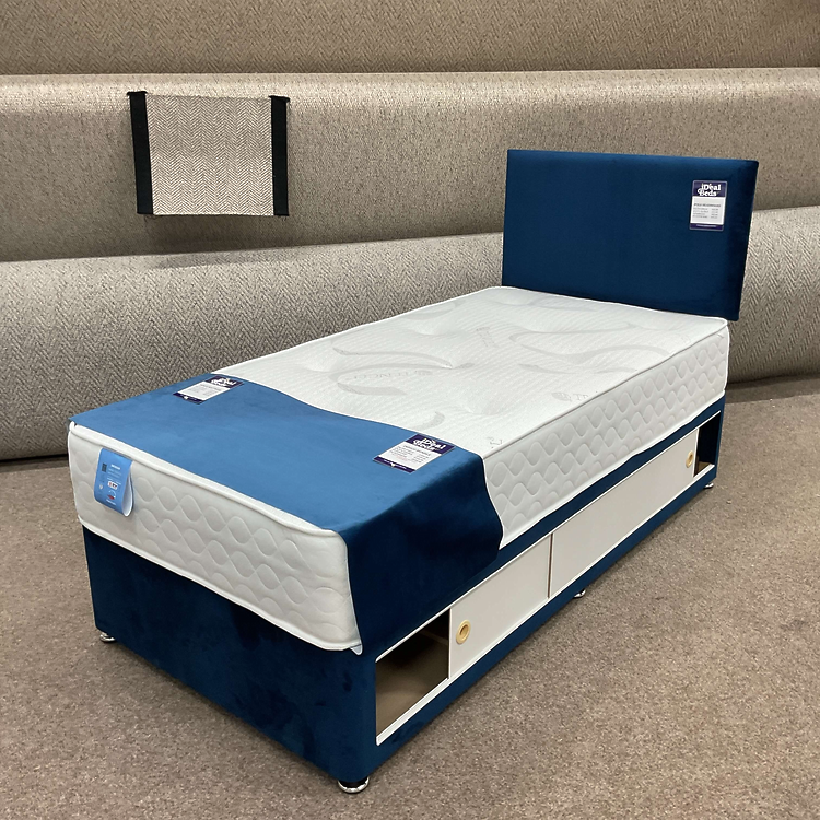 Cream single divan bed with simple headboard and mattress in the Ideal Beds Chesterfield showroom.