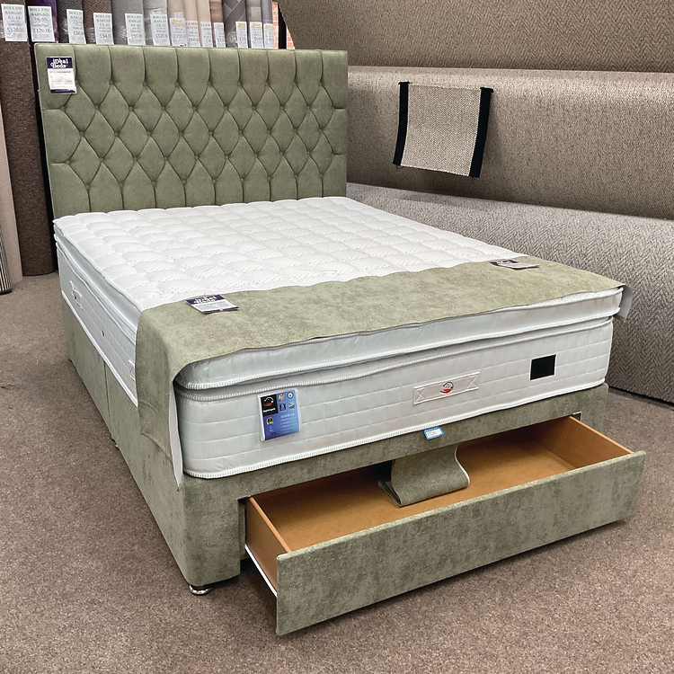 Grey upholstered divan bed with matching headboard and footboard on display at Ideal Beds in Chesterfield.
