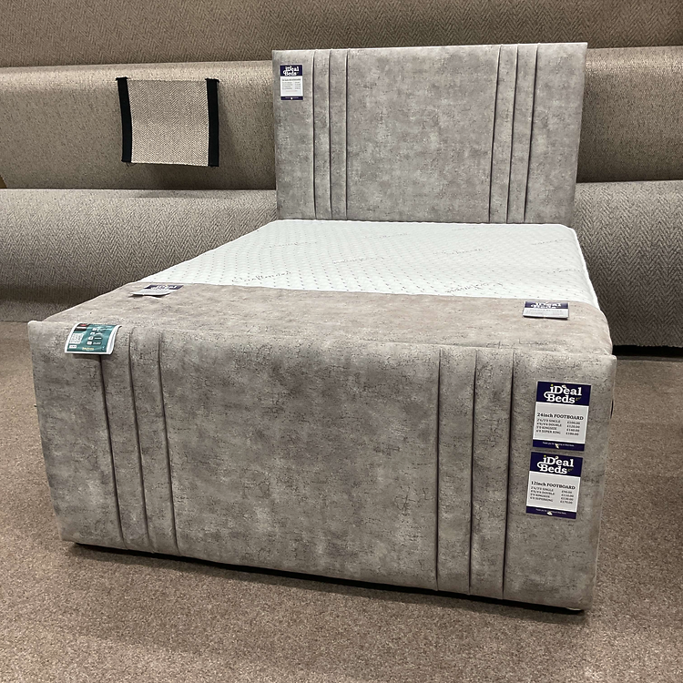 Beige upholstered divan bed with two pull-out drawers and pocket sprung mattress at Ideal Beds in Chesterfield.